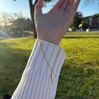 gold necklace with a cross pendant