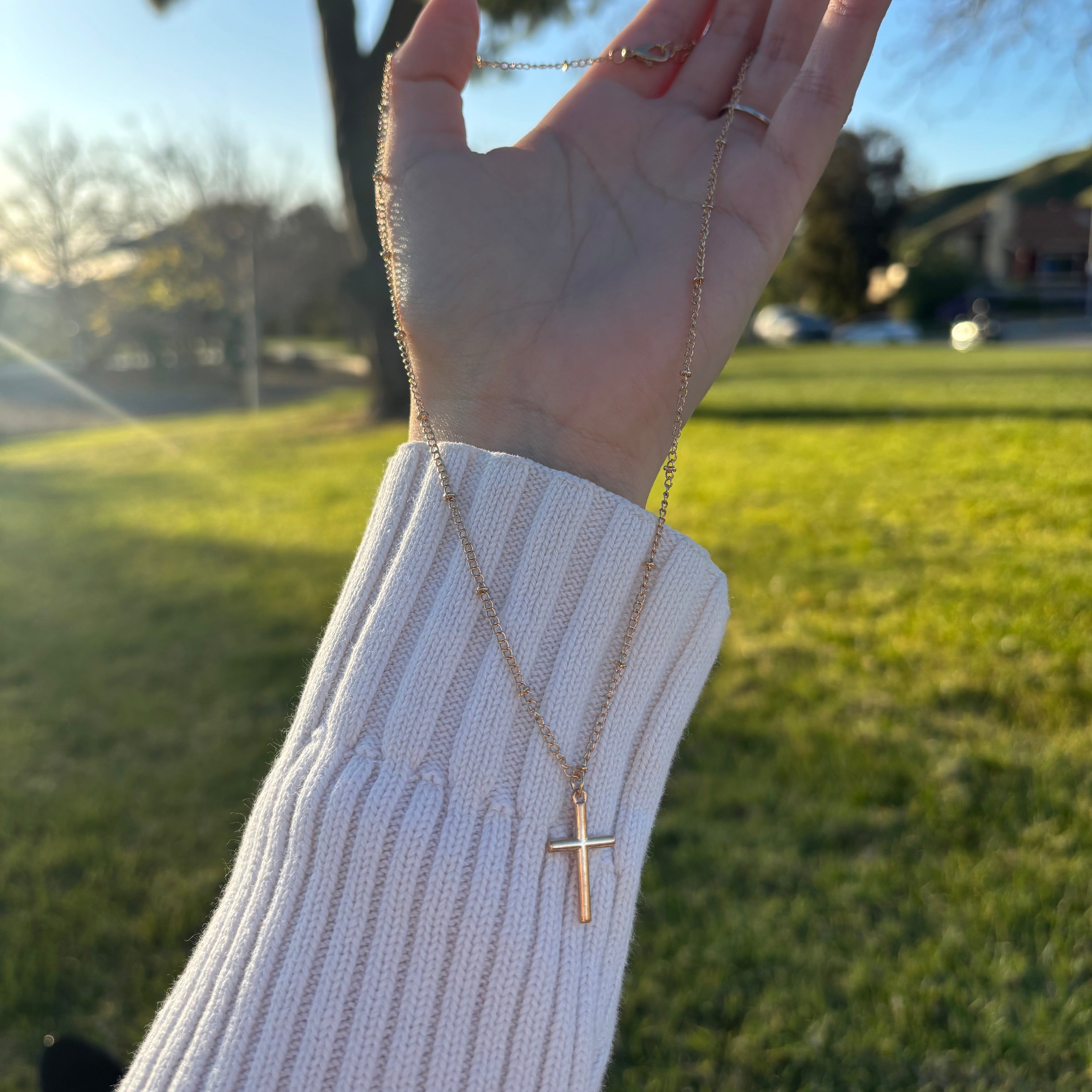 gold necklace with a cross pendant
