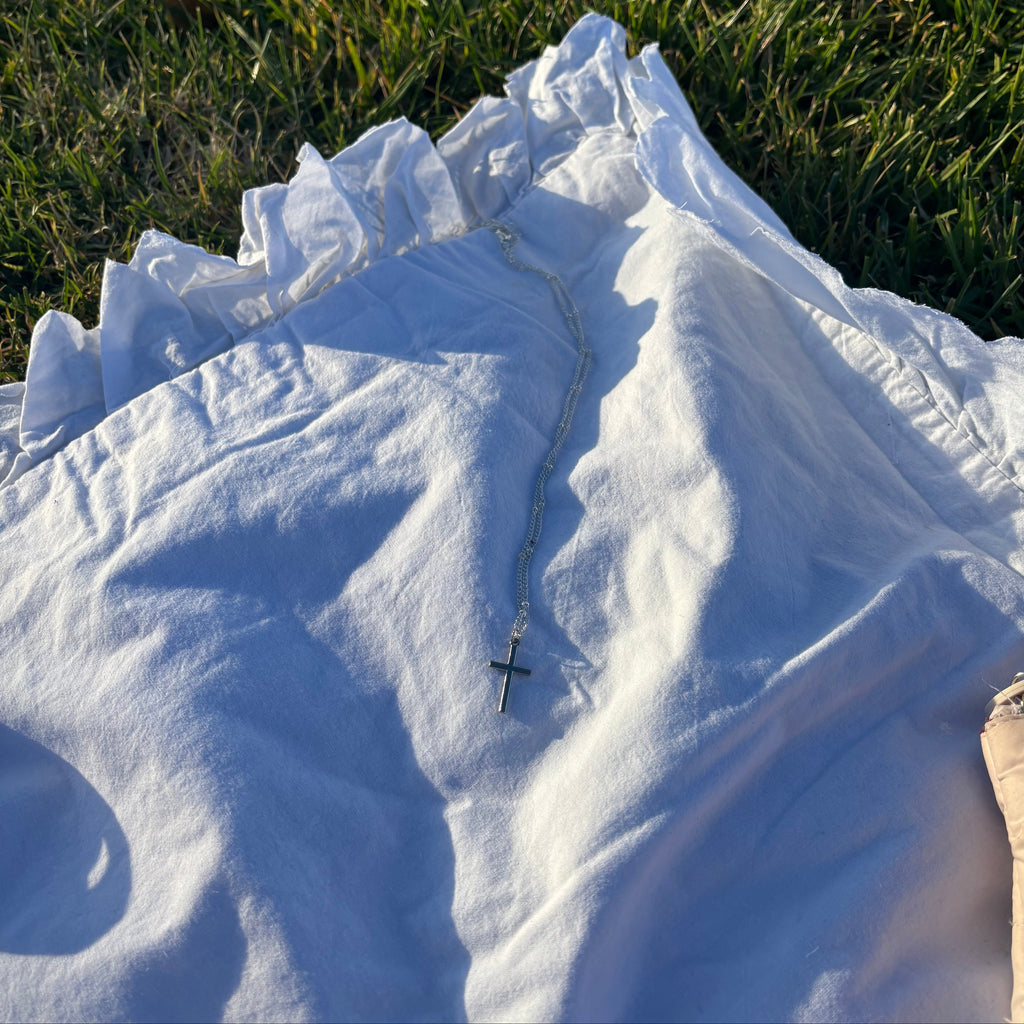 silver necklace with a cross pendant